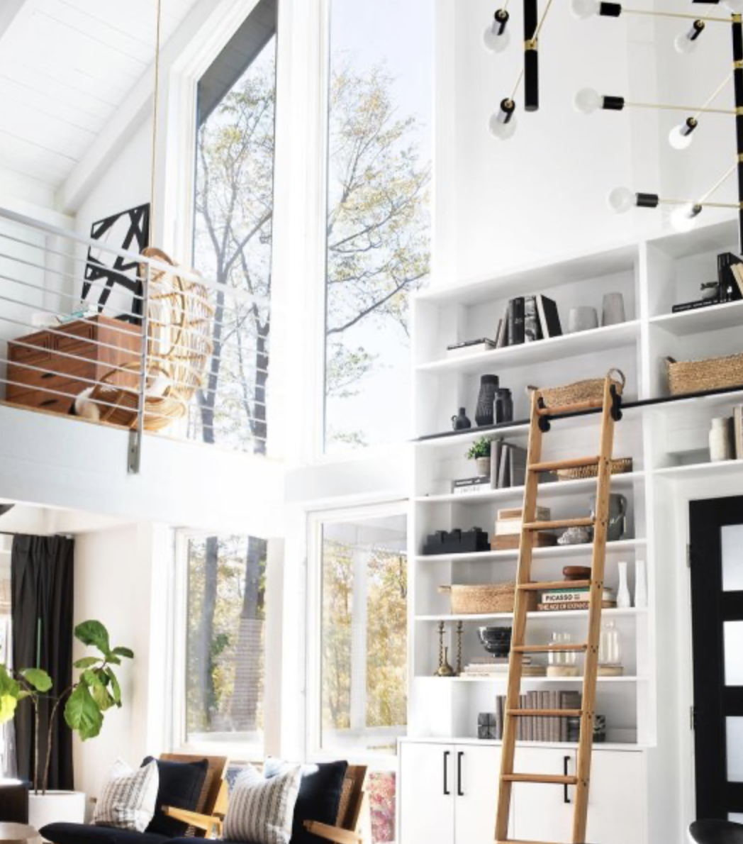 large tall windows let lots of light into a loft and library space