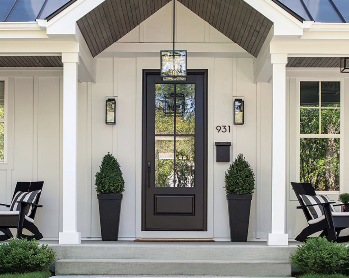 traditional style home with pitched roof entry way black front door