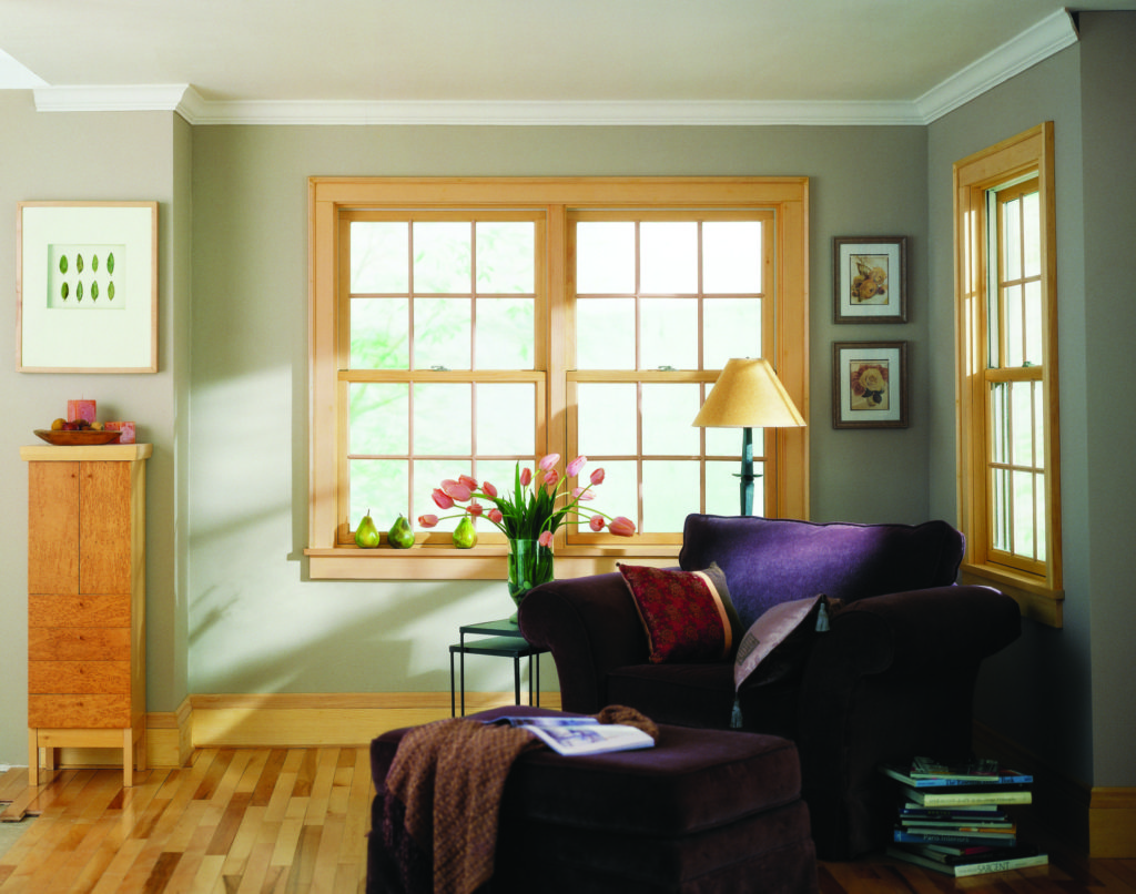 Living room with sage walls and light wood stained Andersen 200 series double hung window