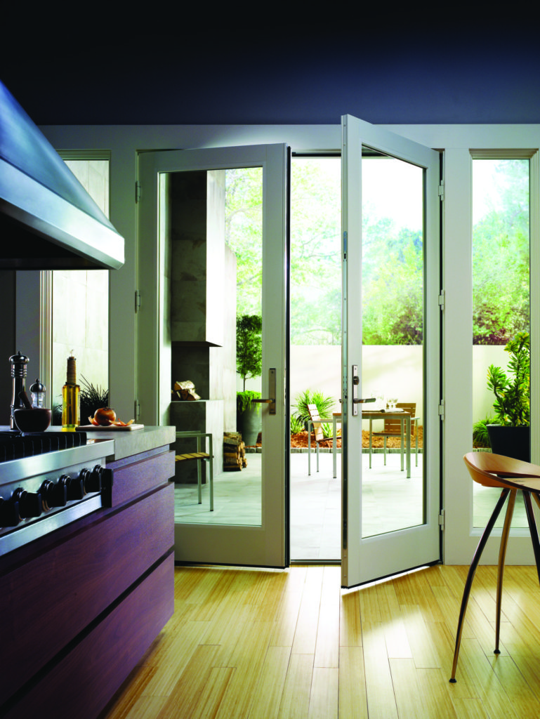 Kitchen bar overlooking back deck through a white Andersen 200 series hinged inswing patio door