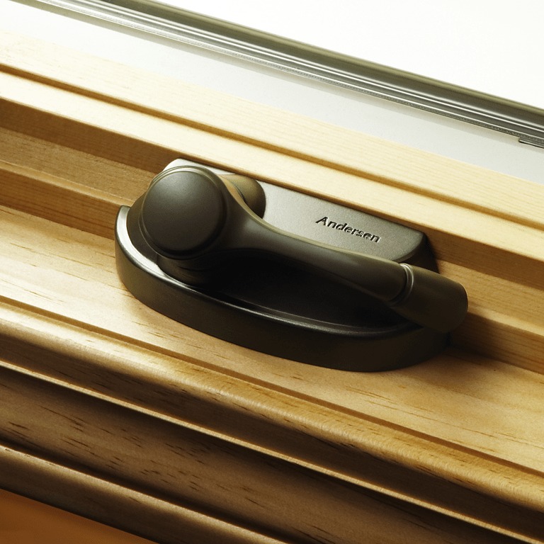 Oil rubbed bronze window lock stamped with Andersen Windows name