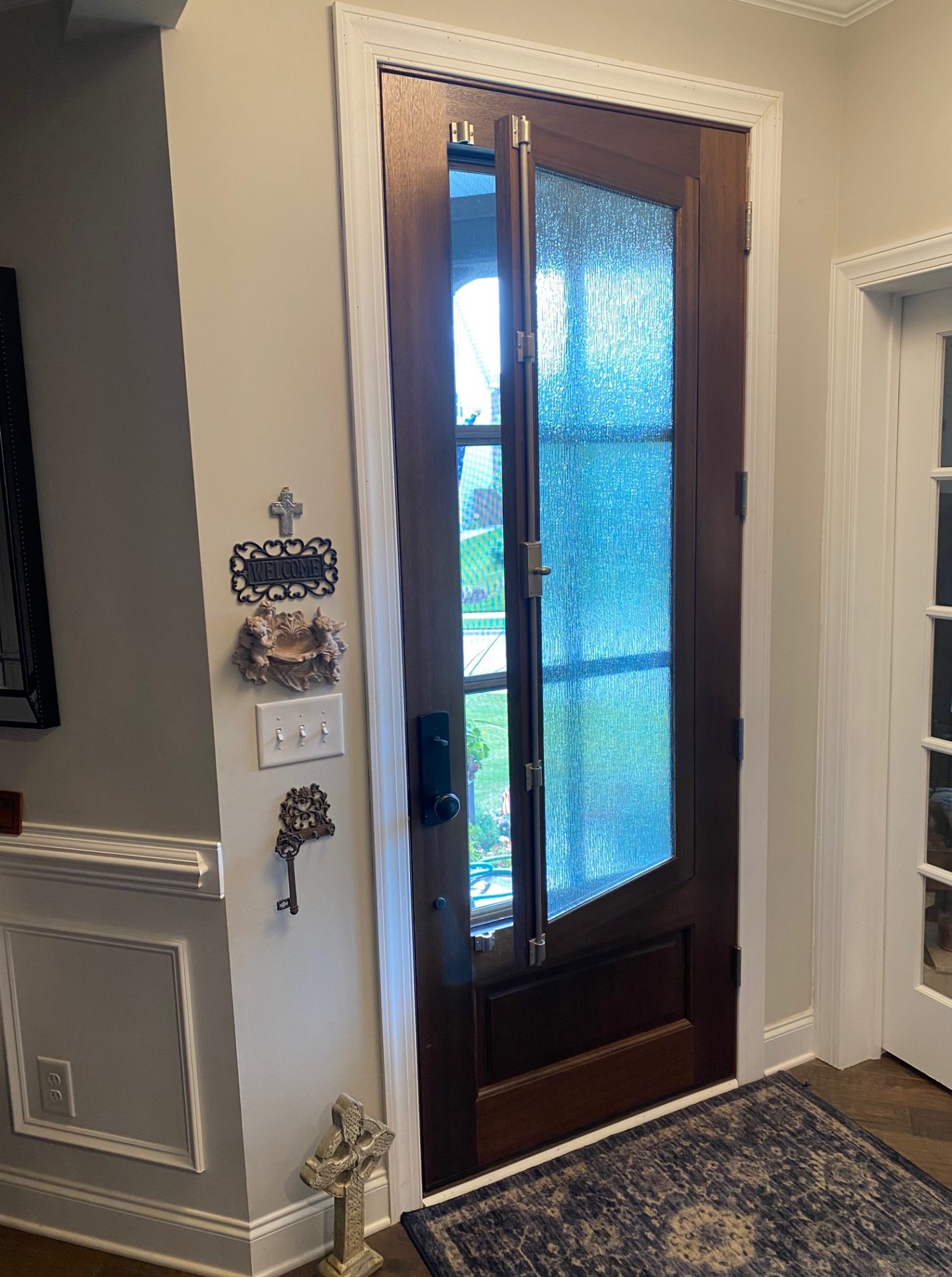 The DSA Breezeport door from inside a home with the venting window partially open. Screens between the six lite portion of the door keep bugs out.