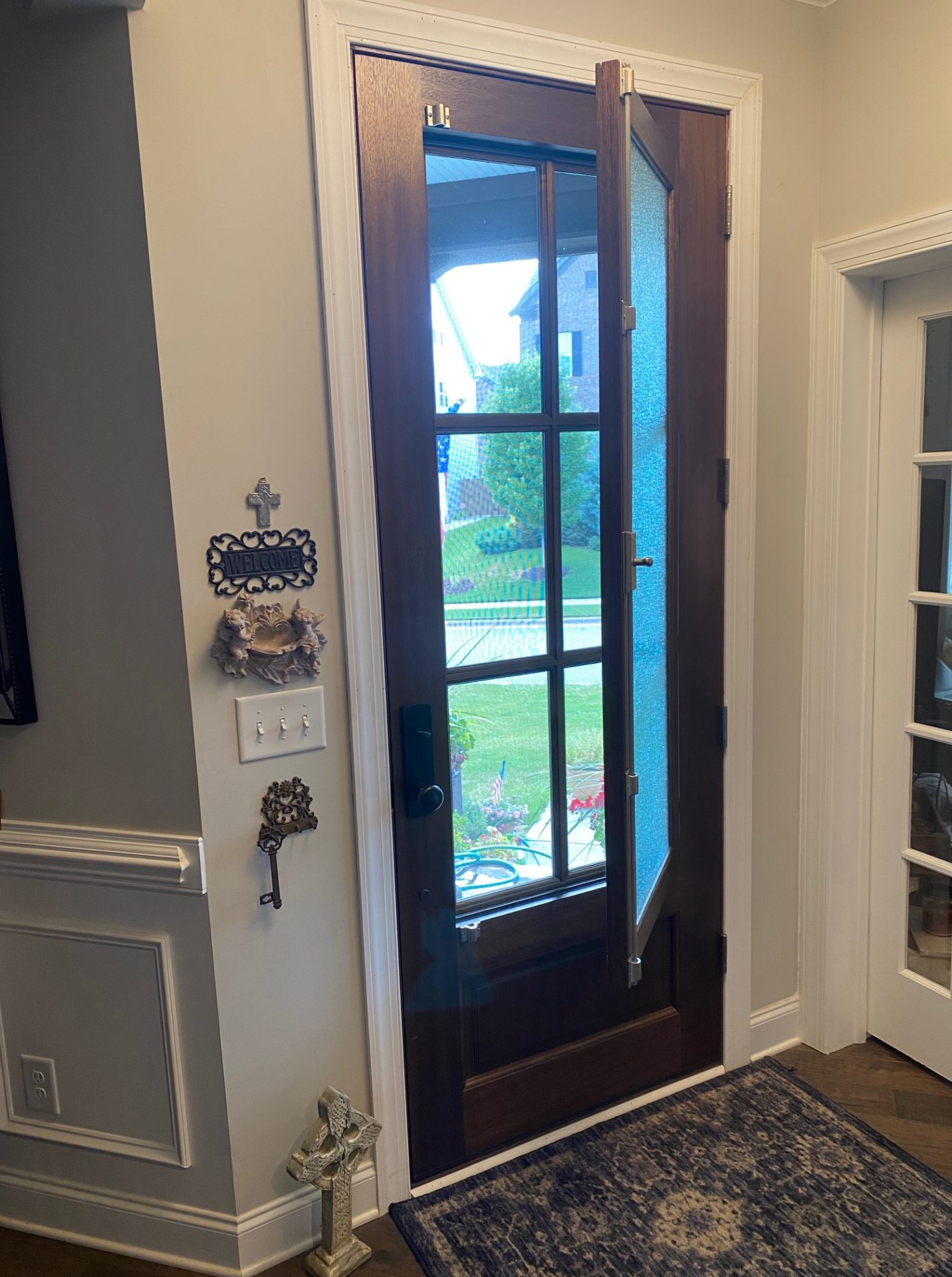 The DSA Breezeport door from inside a home with the venting window partially open. Screens between the six lite portion of the door keep bugs out.