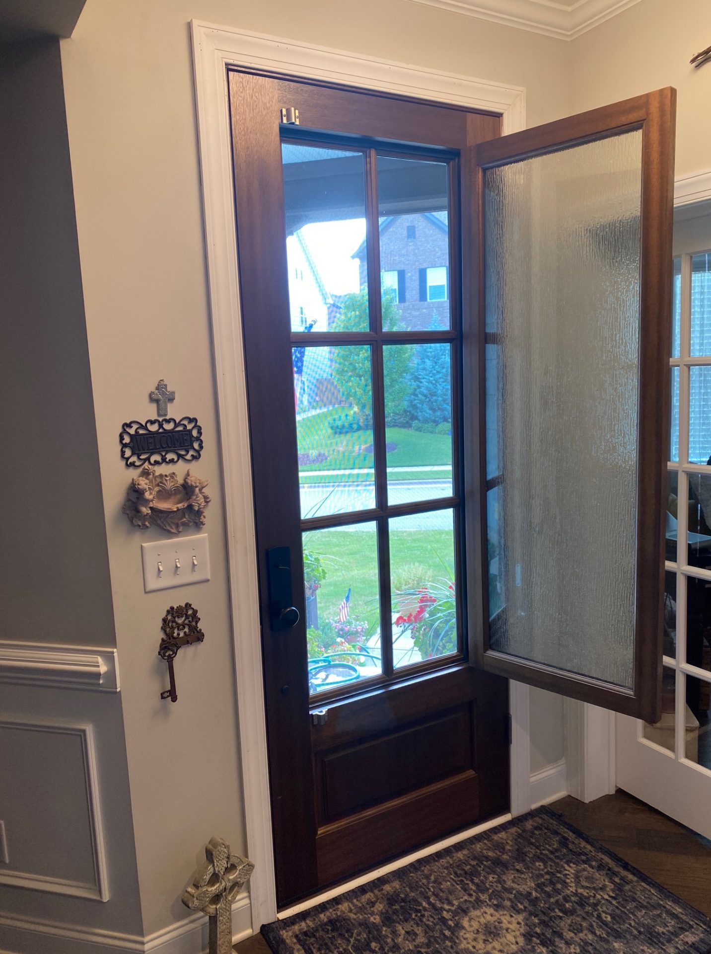 The DSA Breezeport door with the venting window fully opened. With screens to keep bugs out, this door is a stylish, functional, and unique alternative to a Dutch Door.