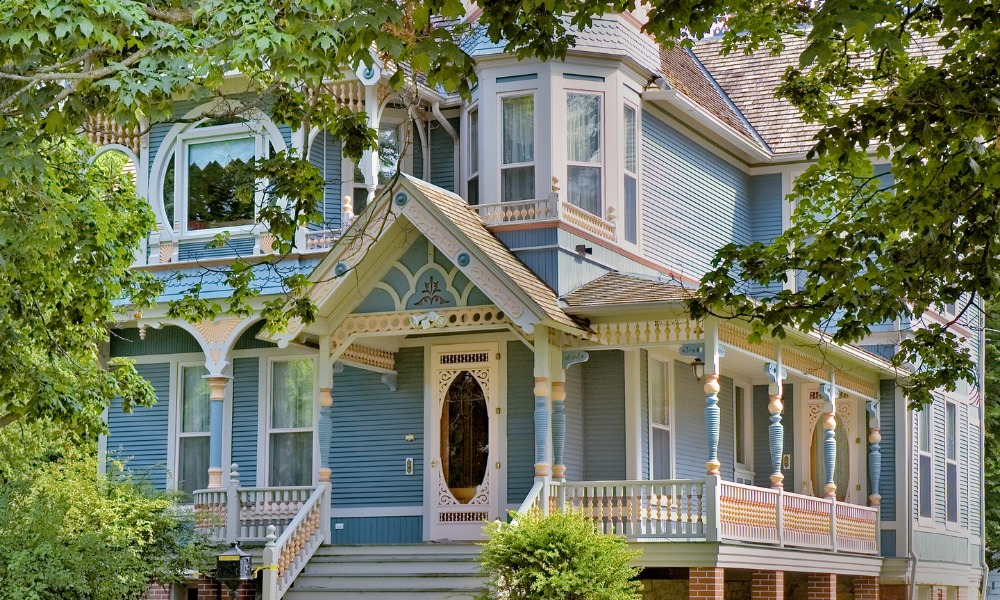 Blue VIctorian historic home with a white front door