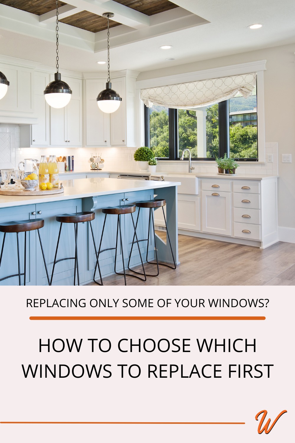 kitchen with a blue island, barstools, and modern pendant lights and a black window overlooking a forest captioned with "replacing only some of my windows: How to choose which windows to replace first?"