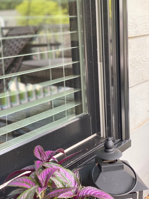 black Aluminum Andersen E-series window with brickmould