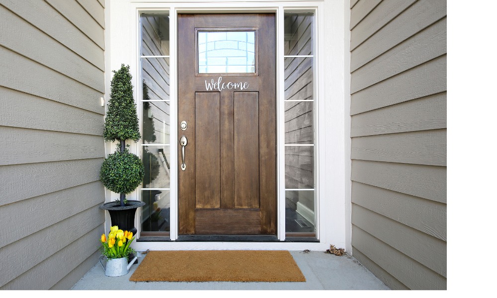 wood quarterlight door with welcome decal and sidelights featuring five grilles