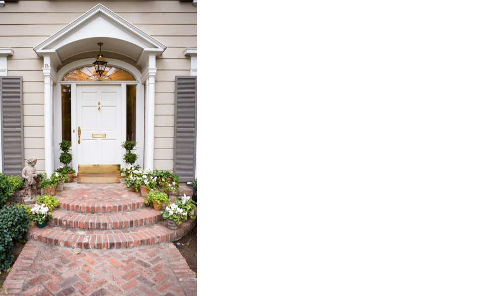 White front door with round transom window on top