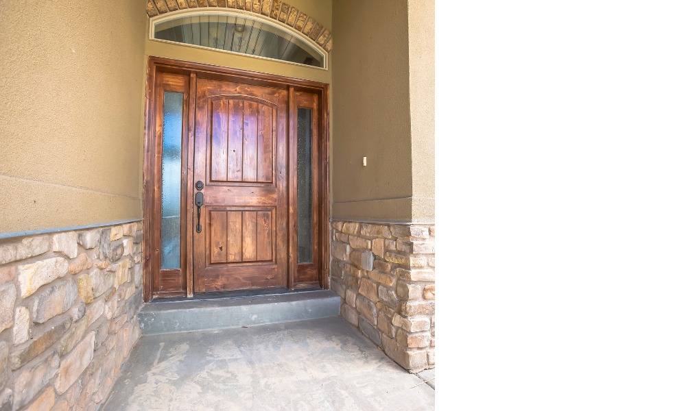 wood front door with rounded transom overtop