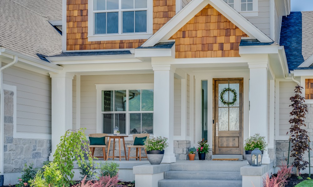 front porch of a townhouse with a fiberglass front door that has been DIY'd to look like wood