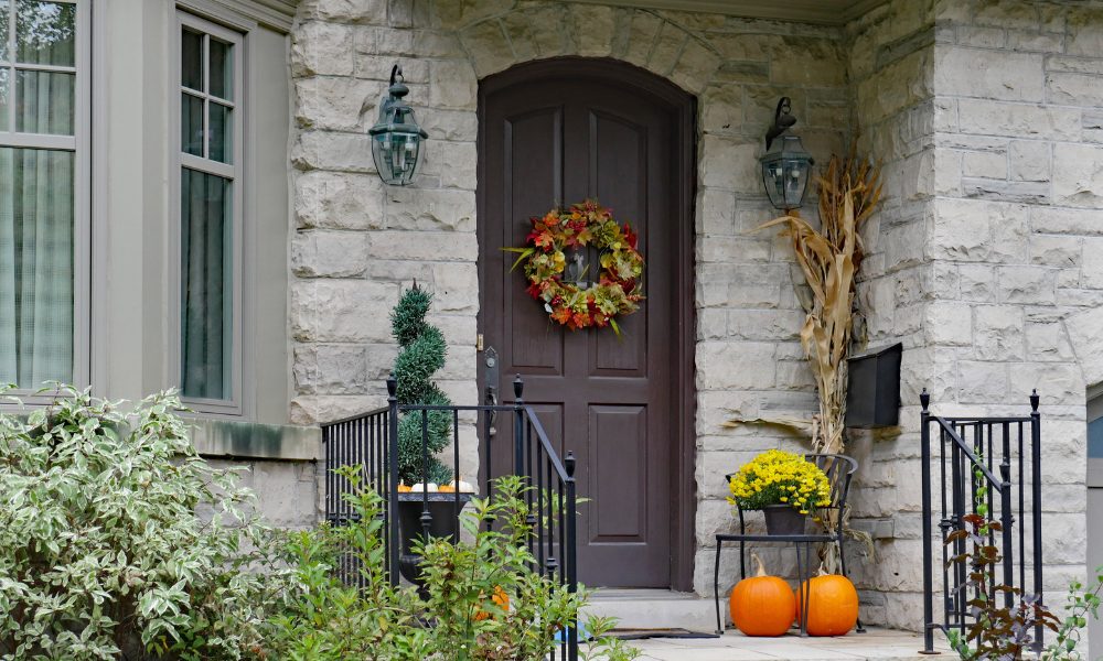 Gray brick home with fall decor