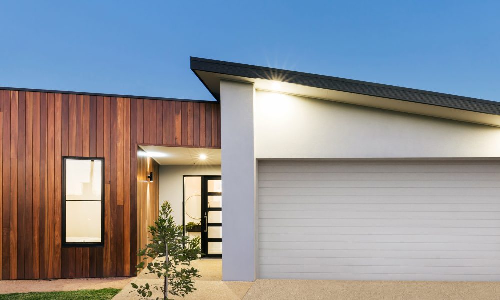 modern architecture home with asymmetrical roof at dusk