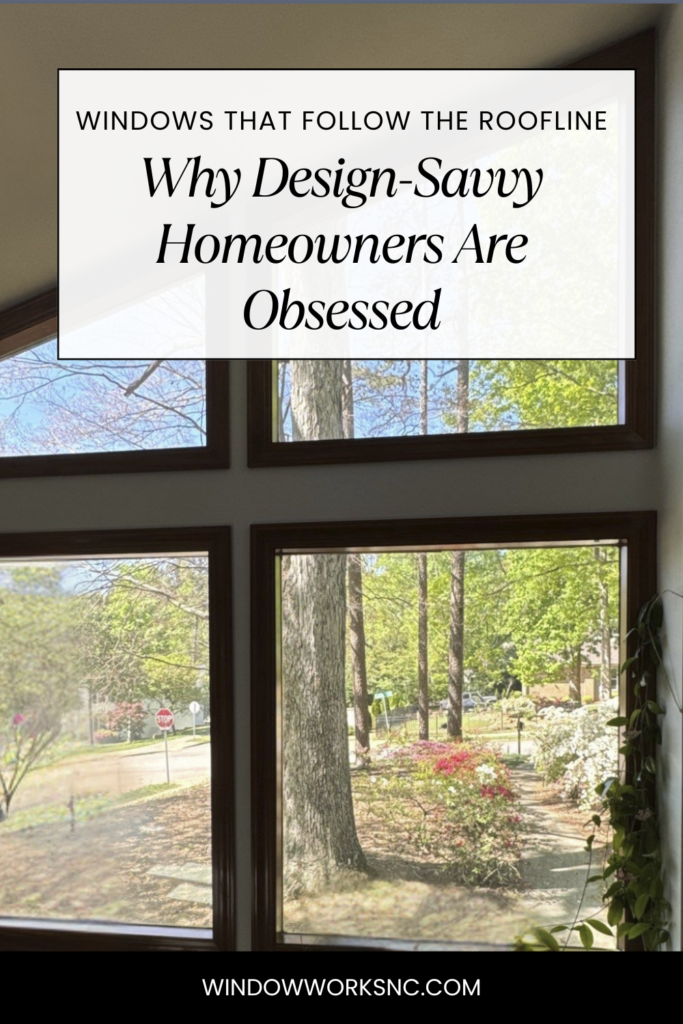 Large windows that follow roofline pitch with dark frames trace the slope of the roof, offering a clear view of a lush, green landscape with trees and shrubs. Text overlay reads: Why Design-Savvy Homeowners Are Obsessed.
